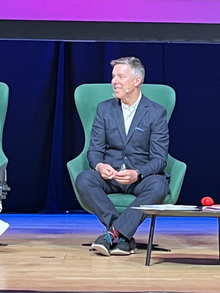 Jonathan sitting in an armchair at the stage listening during the live session.